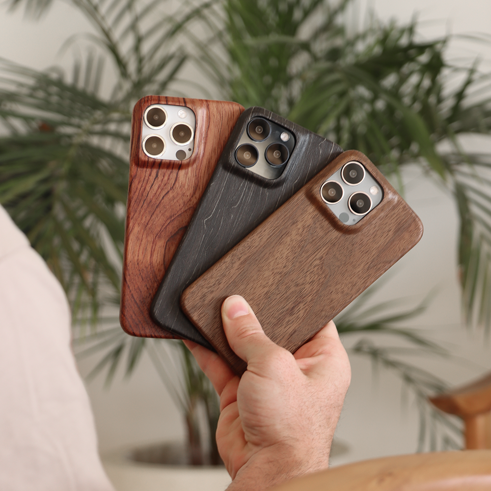 Komodoty Komodo Slim Wood iPhone Case Man holding Rosewood Charcoal and Walnut iPhone Cases