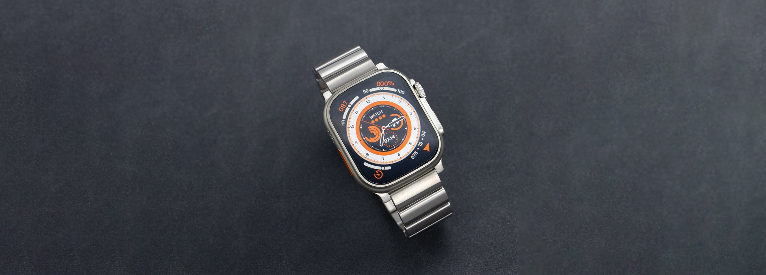 Komodoty Titanium Apple Watch Band Silver Top View of the Face with orange theme banner