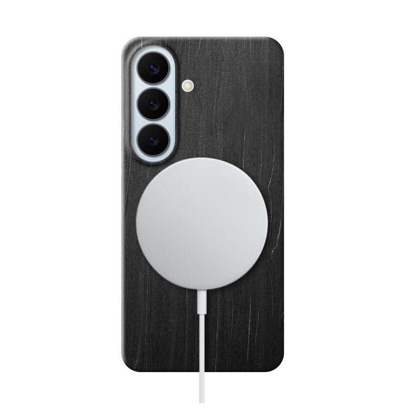 Samsung Galaxy S26 Plus black wood phone case with MagSafe charger attached on white background