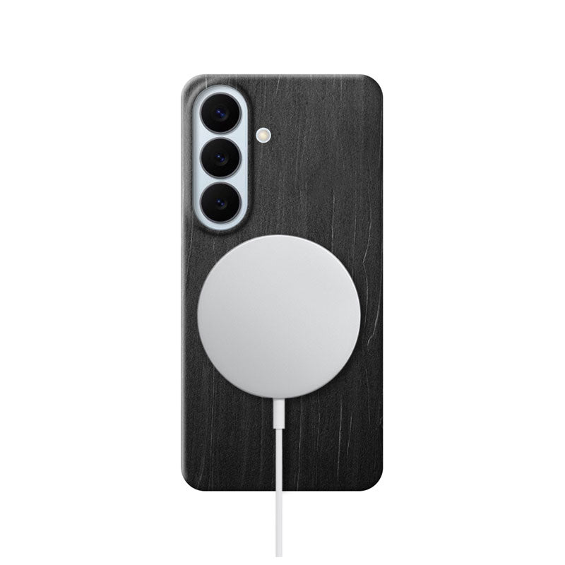 Samsung Galaxy S26 black wood phone case with MagSafe charger attached on white background