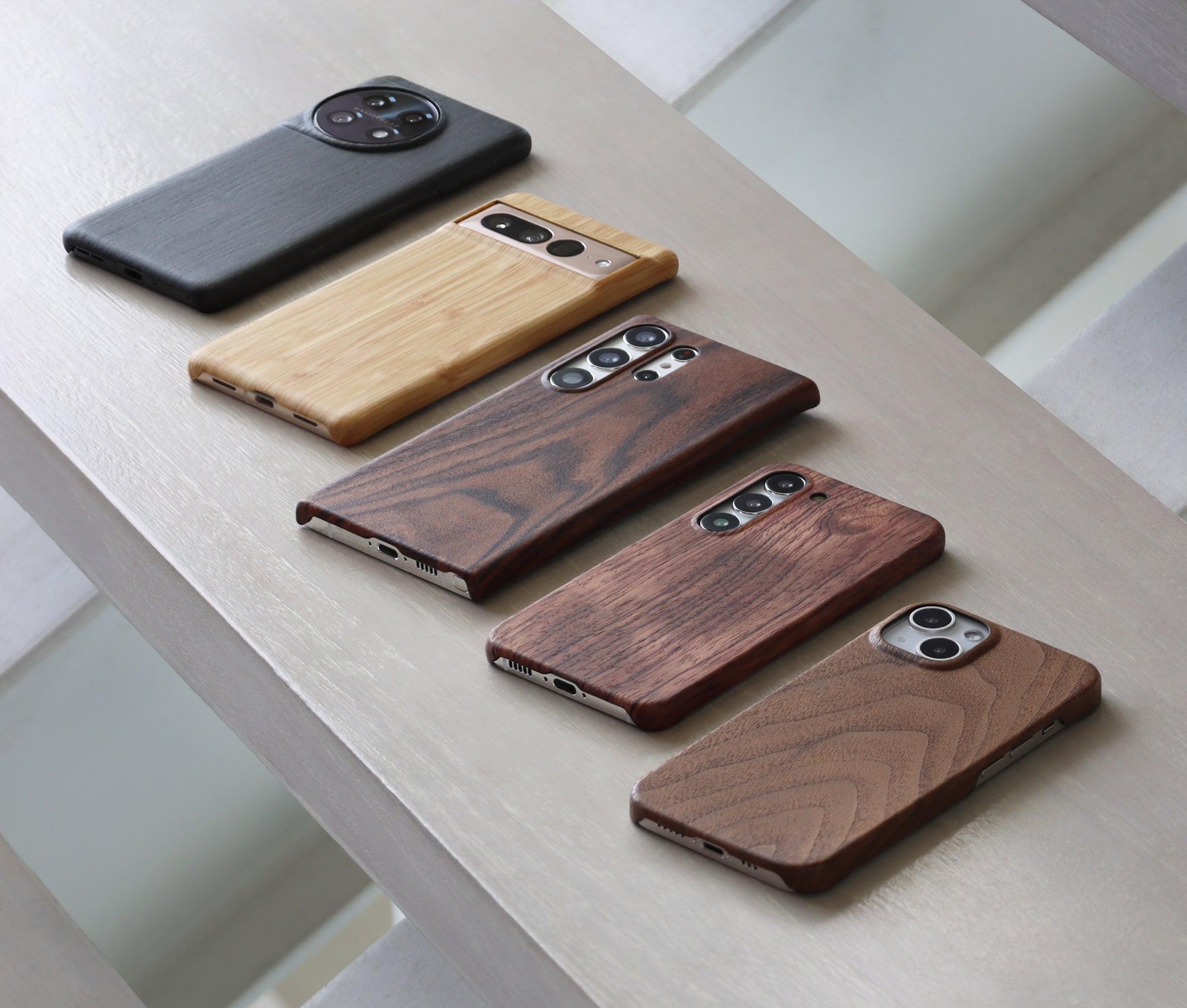 Komodoty Slim Wood Phone Cases iPhone Samsung OnePlus Pixel Walnut Rosewood Mahogany Bamboo Charcoal Flatlay