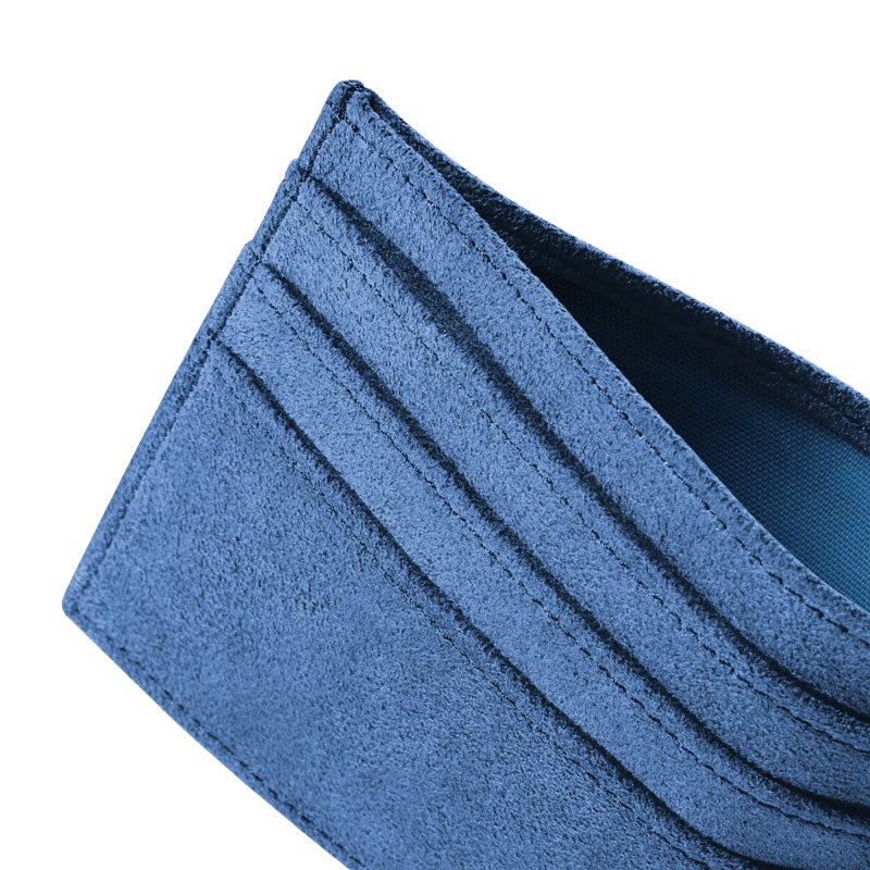 Glacier Blue Alcantara card wallet, macro close-up at an angle showing stitched card slots and suede texture, on a white background