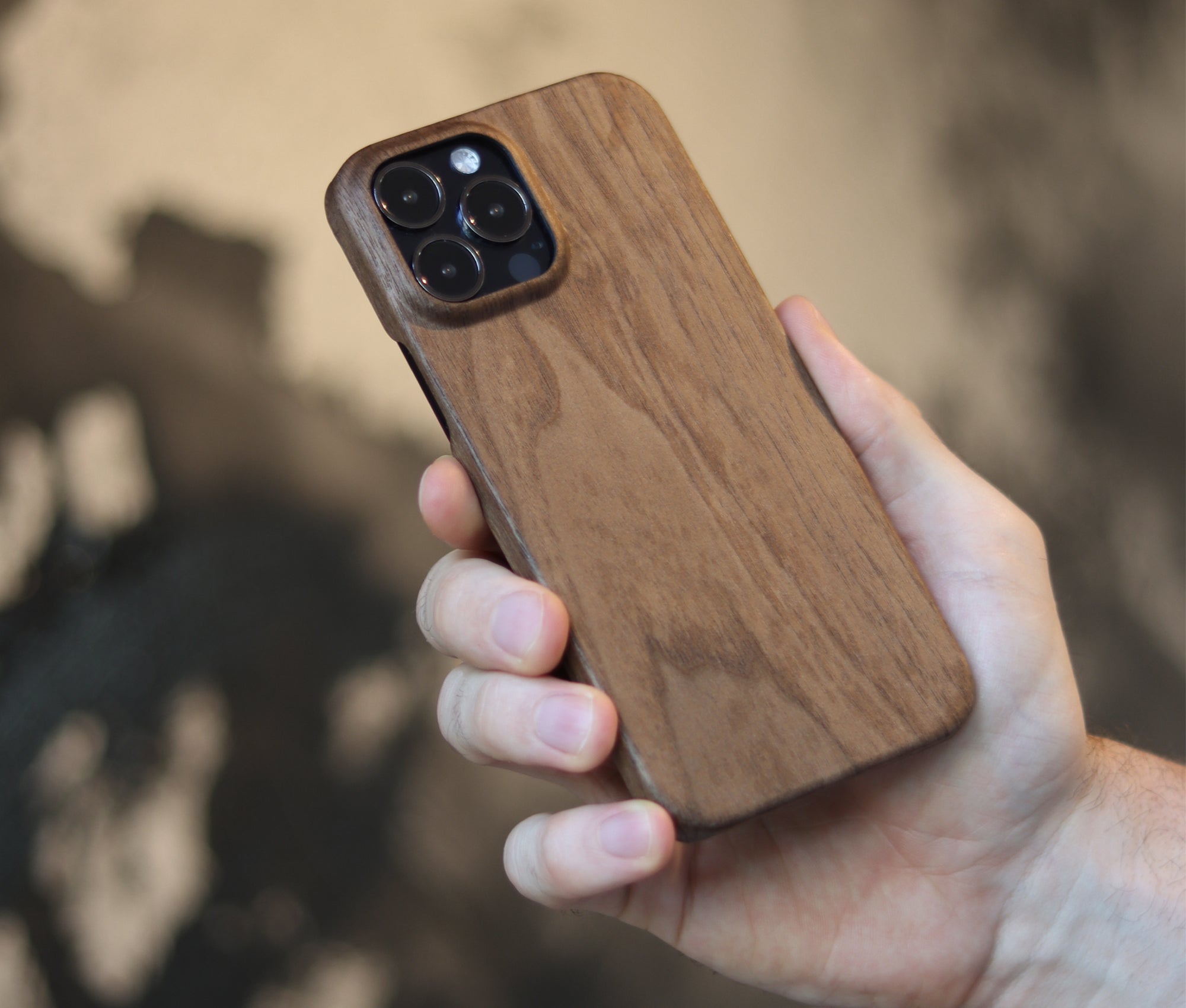 Komodoty man holding Wood iphone Case Walnut finish